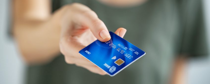 hand holding blue credit card